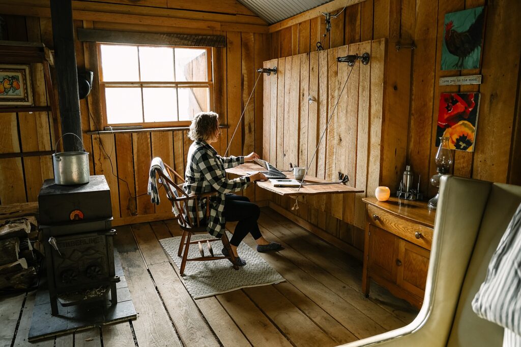 writing at a desk inside Cozy Hipcamp Cabin near Woodstock, Virginia